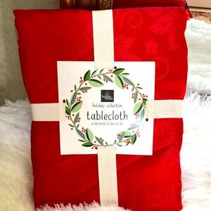 New red Christmas tablecloth with poinsettias.  Size 60” x 84”.  Seats 6-8.